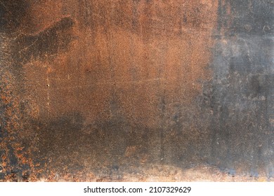 The Inside Of An Old Wood-burning Oven Door. The Metal Sheet Is Covered With Rust And Black Soot. Background. Texture. 