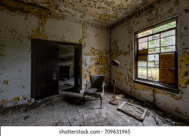 Inside a patient room with some furniture in a long abandoned hospital and nursing home. - Powered by Shutterstock