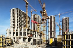 Inside Place For Many Tall Buildings Under Construction And Cranes Under A Blue Sky