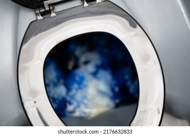 Inside A Portable Toilet With Blue Deodorizing Disinfectant Liquid.