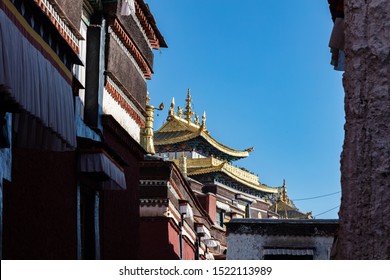 Inside the Potala palace, Lhasa, Tibet, Chine. The golden roof of a temple or dzong inside the Potala palace area One of many small wooden buildings with traditional roof. amazing landscape of Tibet