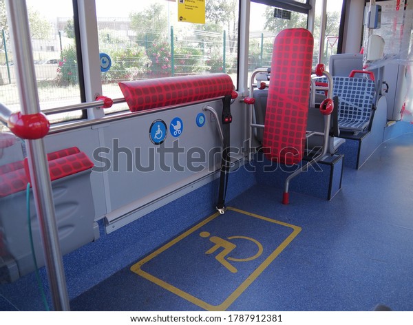 Inside a\
public bus, reserved seat label on-board bus for disabled people.\
Barcelona public transport, icon for\
wheelchair