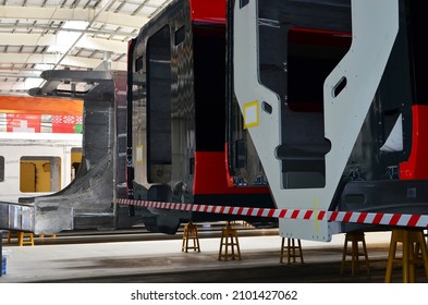 Inside Of The Rail Car Assembly Plant. Industrial Workshop For Production Of High Speed Trains. Factory Of Manufacturing Trainsets Passenger Rolling Stock. Painting A Body Train Car In Paint Shop.