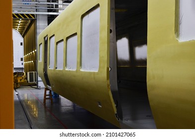 Inside Of The Rail Car Assembly Plant. Industrial Workshop For Production Of High Speed Trains. Factory Of Manufacturing Trainsets Passenger Rolling Stock. Painting A Body Train Car In Paint Shop.