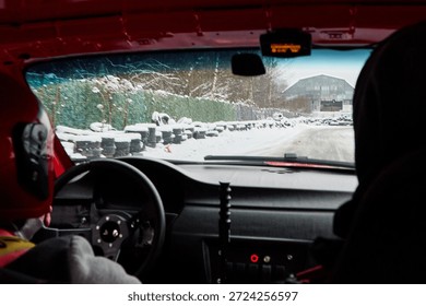 Inside rally car navigating snowcovered mountain stages with focus