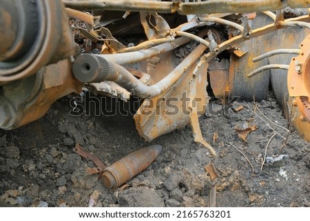 Inside of smashed and burned russian tanks. Destroyed tank. War in Ukraine. Russian projectile shell without detonation and explosion