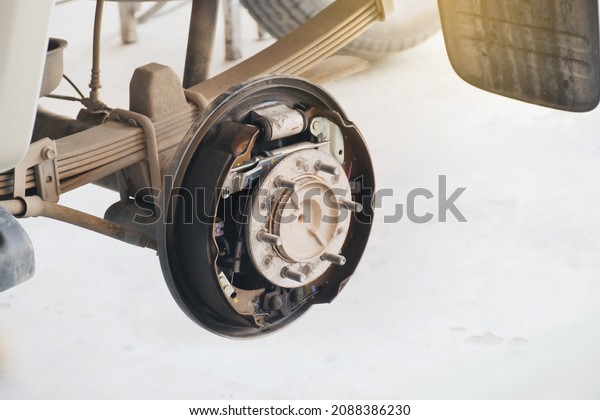 Inside system of the\
car drum brake, car without a wheel for brake inspection in the\
auto repair garage