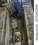 Inside of Ta Prohm temples with walking pathway and stone roofs with artistic carvings on them. Ancient Khmer  temple buildings in the early twentieth century yet still standing strong in Cambodia 