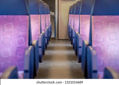 Inside the train bogie with empty chairs, Second class train interior, Seat places in backside of modern public intercity train, Netherlands.
