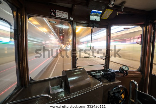 Inside a Tram car\
rushing through Hong Kong island streets at night. WIde angle and\
long exposure are used.
