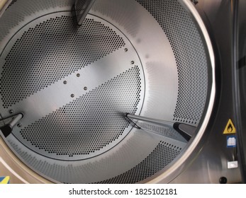 Inside A Tumble Dryer. The drying tank is made of perforated stainless steel for the front-loading tumble dryer. Focus close and choose the subject.