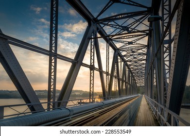 Inside view of big steel railway bridge on sunrise. Savonlinna, Finland