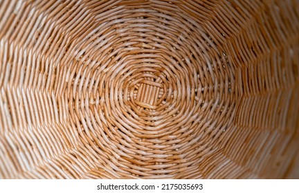 Inside View Of The Bottom Of A Basket Woven From Twisted Paper Tubes. Textured Wicker Surface. Fragment Of A Brown Wicker Basket As A Background Texture Composition. Handmade, Hobbies. Close Up.