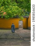 Inside view of a Buddhist temple, with a monk walking.