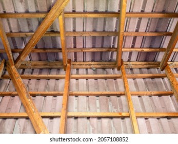 Inside View Of Ceramic Tile Roof With Wooden Rafters And Purlins