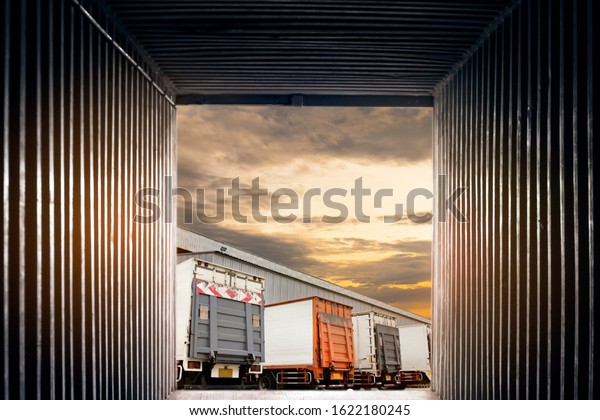 Inside view container\
shipping with a truck parking at warehouse, freight industry\
logistics and transport