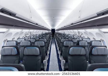 Inside view of empty airplane cabin with modern cabin interior in economy class