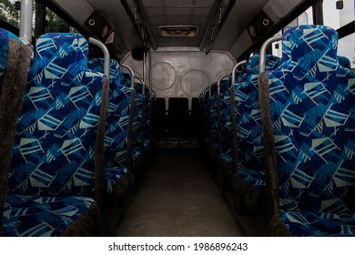 An Inside View Of An Empty Bus With Blue Seat Covers