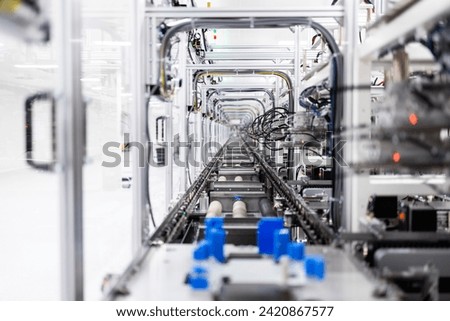 Inside view of high tech automated industrial machine producing electronics components.