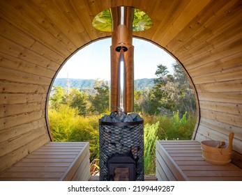 The inside view of the outdoor barrel sauna in the wild.