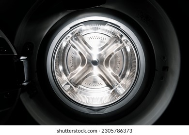 Inside of washing machine. Rotating inner tub. Material metal. Close up of electrical household appliance. - Powered by Shutterstock