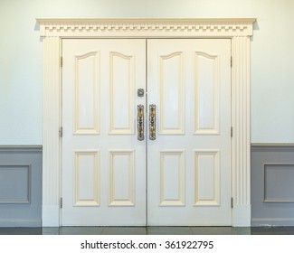 Inside White Double Doors With Ornate Handles And Lock. Closed.