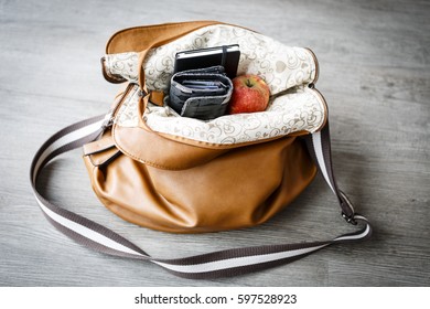 Inside Woman Leather Handbag On The Wooden Floor