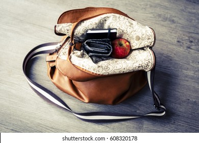 Inside Woman Leather Handbag On The Wooden Floor