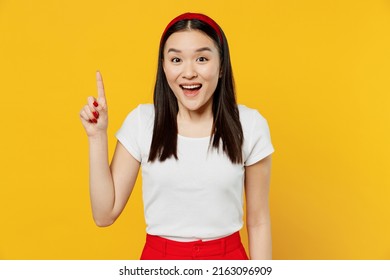 Insighted Fun Smart Proactive Fancy Young Woman Of Asian Ethnicity She 20s Years Old Wears White T-shirt Holding Index Finger Up With Great New Idea Isolated On Plain Yellow Background Studio Portrait