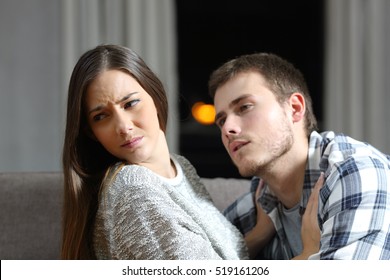 Insistent Man Trying To Get Sex And His Worried Girlfriend Denying On A Couch In The Night At Home