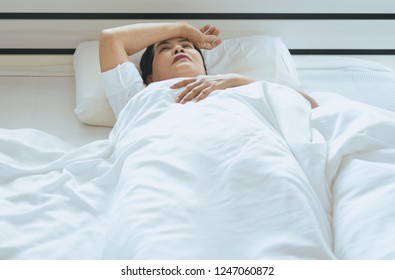 Insomnia In Elderly Asian Women On Her Bedroom,Woman Awake In The Night And Lying Suffering From Headache In The House