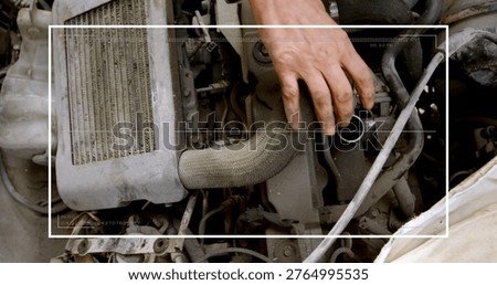 Inspecting bare right hand reaching into car engine bay, touching wrapped hose, filler, white frame. Vehicle, mechanic, garage, radiator, intercooler, coolant, forearm