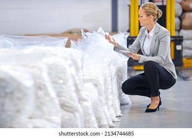 Inspecting the quality of their stock. Shot of a female factory manager doing an inspection of raw materials. - Shutterstock ID 2134744685