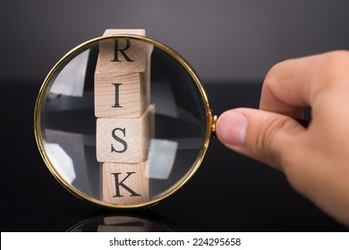 Inspecting Risk Blocks With Loupe Over Black Background