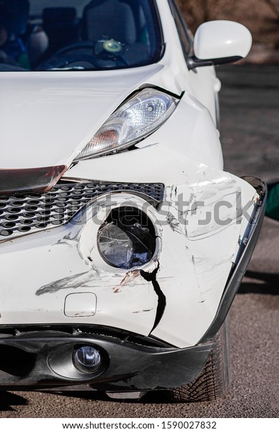 Inspection of the car after an accident on the\
road. Car accident or accident. The front wing and the right\
headlight are broken, damage and scratches on the bumper. Broken\
car parts or\
close-up.