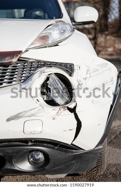 Inspection of the car after an accident on the
road. Car accident or accident. The front wing and the right
headlight are broken, damage and scratches on the bumper. Broken
car parts or
close-up.
