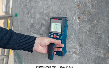 Inspection of the reliability of concrete structures. A device for ultrasonic examination of concrete, engineering background. Safe building concept.