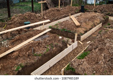 inspection wells, drainage pipes and trench with formwork, which is prepared for pouring the foundation - Shutterstock ID 1087985189