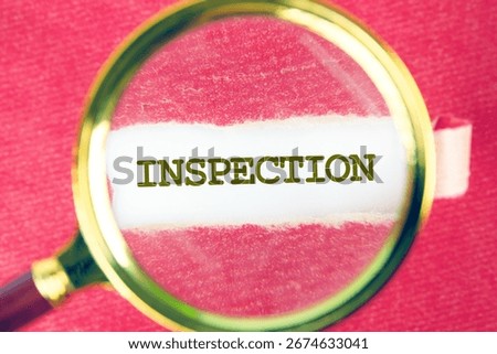 INSPECTION word was found using a magnifying glass under a piece of paper. Inspection Industry Concept