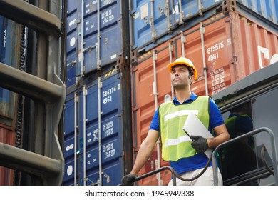 inspector checking container yard Organising stock to pack into containers, Unload and loading variety of products to and from container, trucks warehouse. imported product, Logistics