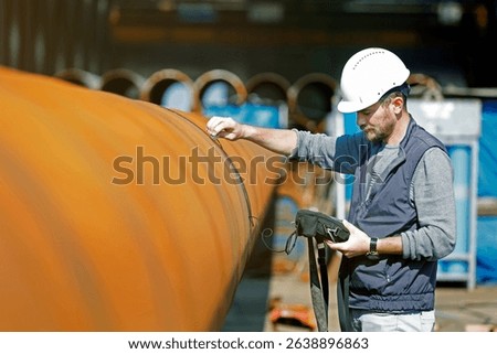 Inspector is checking welds with ultrasonic test method. It is a family of non-destructive testing techniques based on the propagation of ultrasonic waves in the object or material tested.