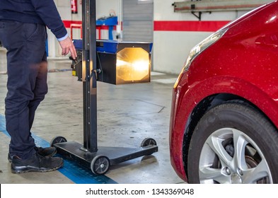 Inspector Doing A Checking Of The Headlights With A Headlight Tester