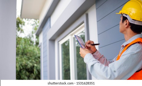 The inspector or engineer is checking the building structure and the requirements of the wall paint. After the renovation is completed - Shutterstock ID 1531628351