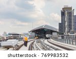 Inspector (Engineer) checking railway construction work on skytrain viaduct. Which railway consist of rail track and conductor rail or third rail.