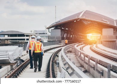 Inspector (Engineer) checking railway construction work on skytrain viaduct. Which railway consist of rail track and conductor rail or third rail.