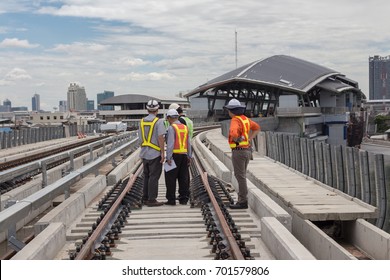 Inspector (Engineer) checking railway or track on viaduct of sky train. Selective focus