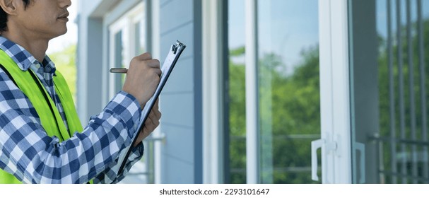 inspector or engineer is inspecting construction and quality assurance new house using a checklist. Engineers or architects or contactor work to build the house before handing it over to the homeowner