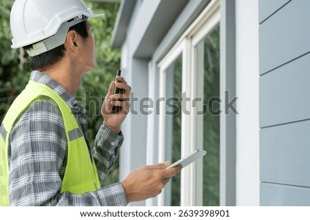 inspector or engineer is inspecting construction and quality assurance new house using a checklist. Engineers or architects or contactor work to build the house before handing it over to the homeowner