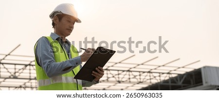 inspector or engineer is inspecting construction and quality assurance new house using a checklist. Engineers or architects or contactor work to build the house before handing it over to the homeowner