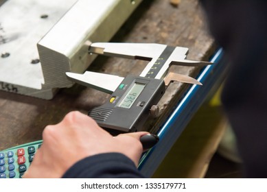 Inspector is measuring the mock up with vernier caliper in manufacturing during an observing and inspecting of client  - Shutterstock ID 1335179771